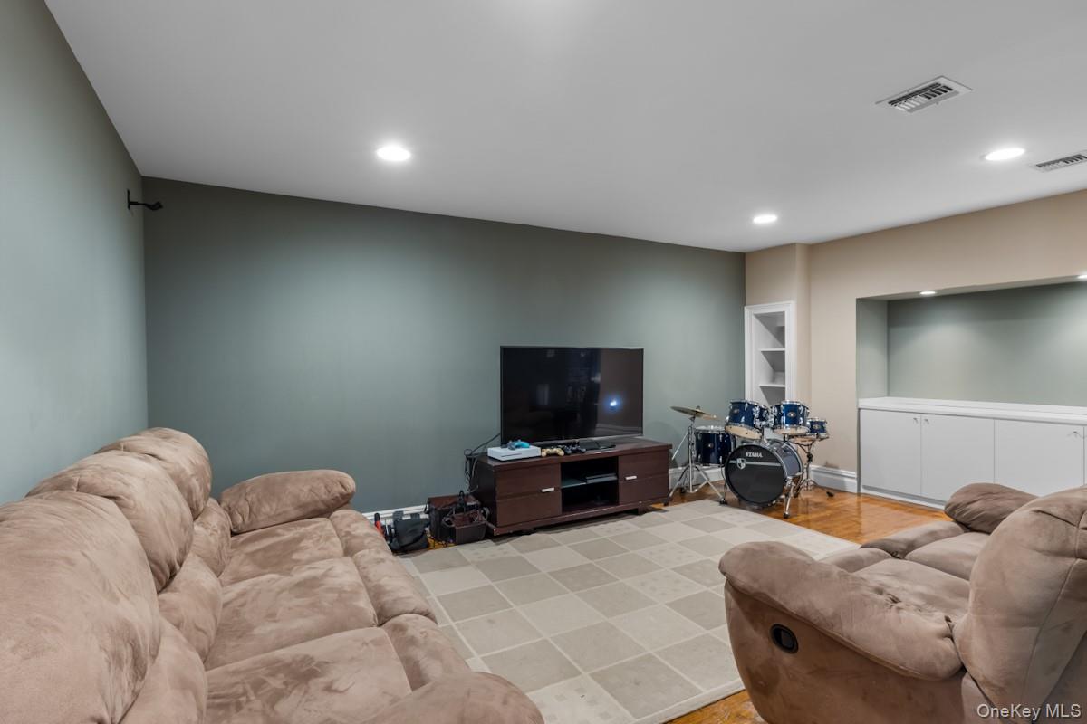 9 Ronwood Road Chestnut Ridge, NY 10977 - Photo 37 of 48 a living room with furniture and a flat screen tv
