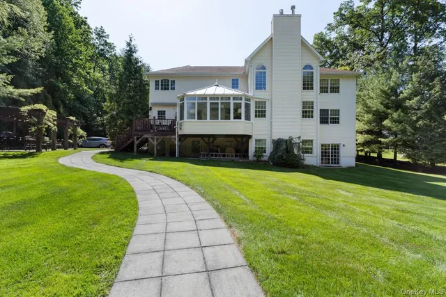 a view of a chair and table in backyard of the house