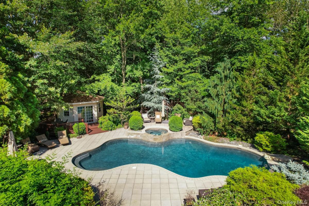 9 Ronwood Road Chestnut Ridge, NY 10977 - Photo 4 of 48 a view of a backyard with table and chairs potted plants and large tree