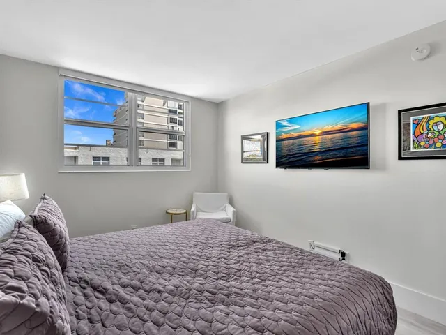 a bathroom with a shower sink vanity mirror and toilet