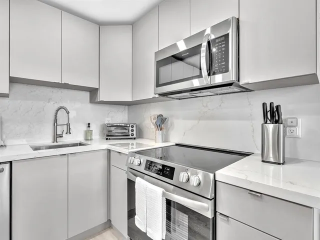 a kitchen with a refrigerator and a sink