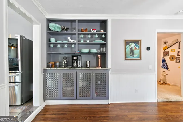 a view of open kitchen with wooden floor and cabinet