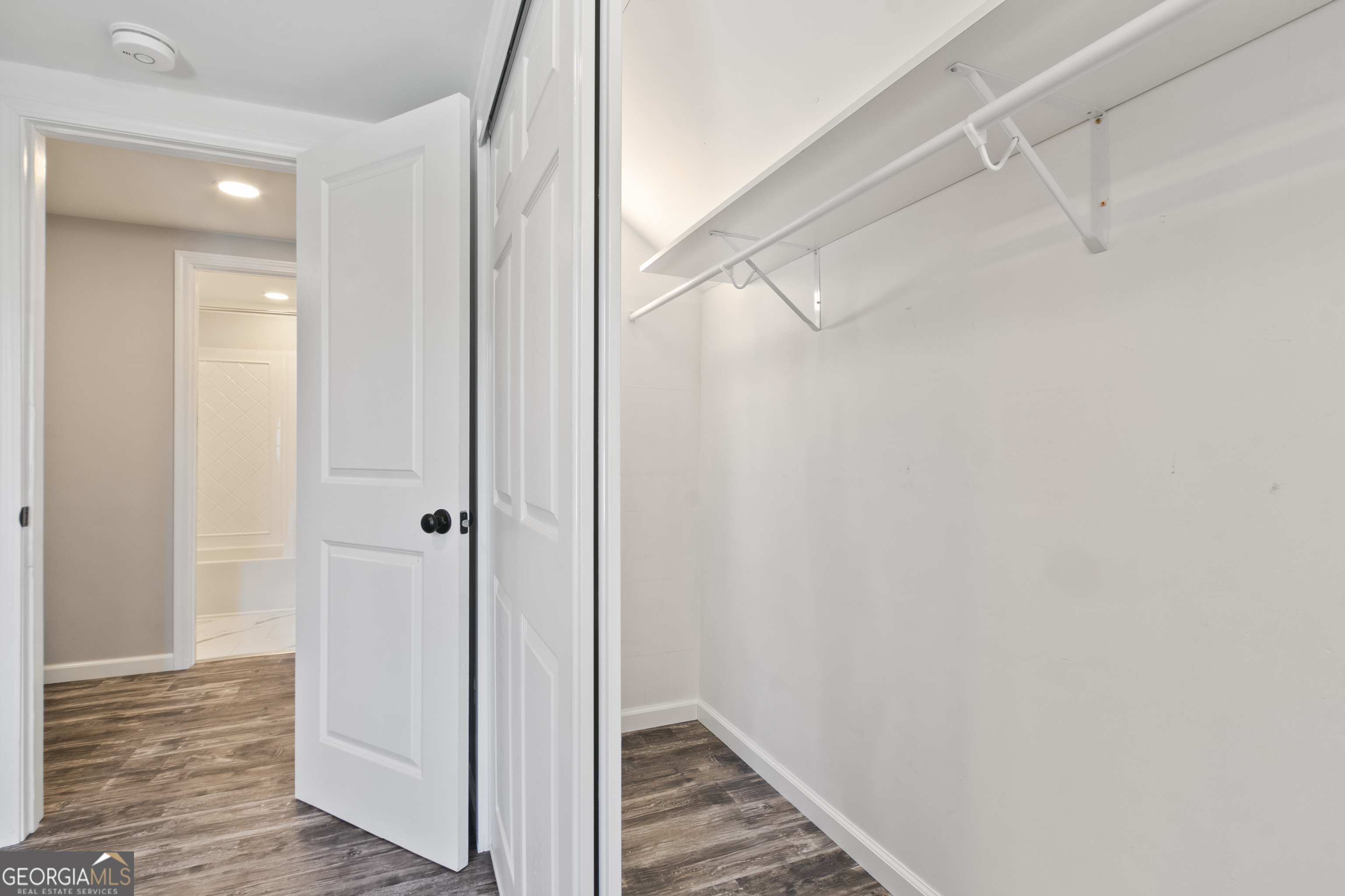 61 Clark Street Newnan, GA 30263 - Photo 23 of 37 a view of hallway with closet and wooden floor