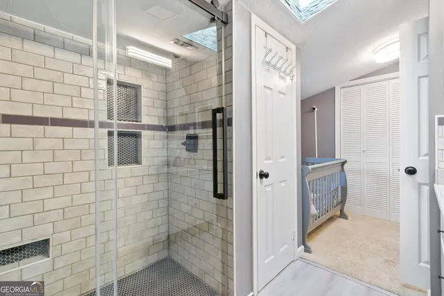 a bathroom with a shower and a sink
