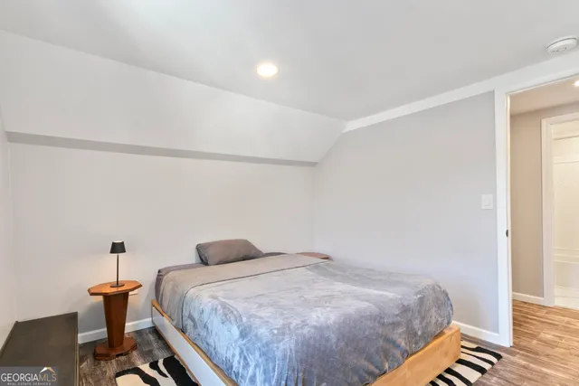 a bedroom with bed and a table