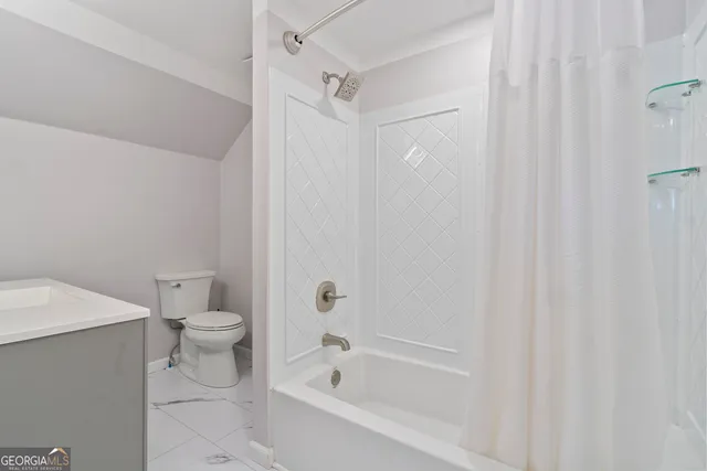 a bathroom with a toilet and a bathtub