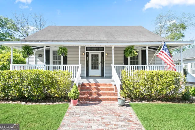 a front view of a house with a garden