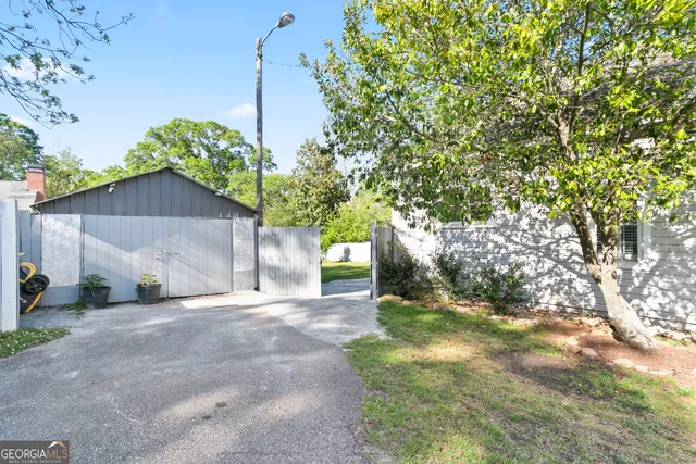 a backyard of a house with plants and trees