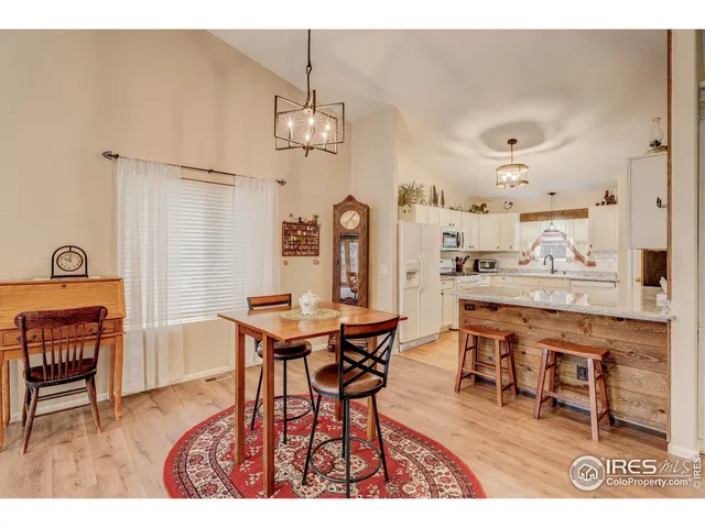 a view of a dining room with furniture and chandelier