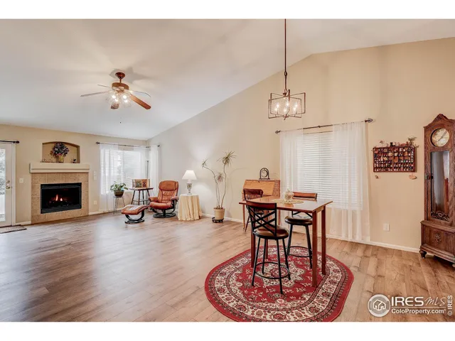a living room with furniture a fireplace and a chandelier