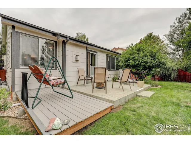 a view of a house with backyard porch and sitting area