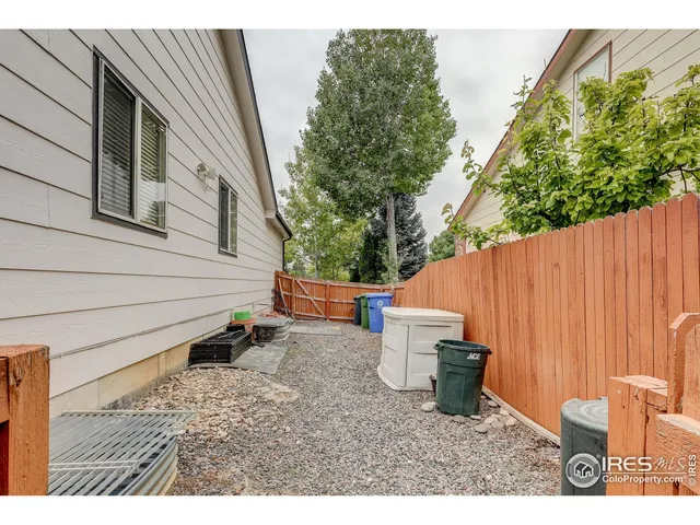 a backyard of a house with table and chairs