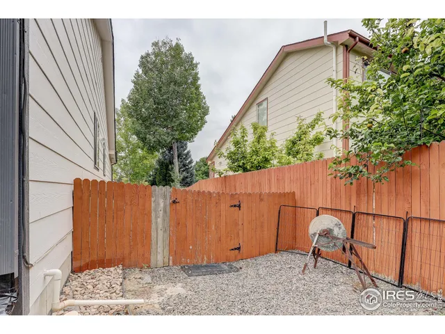 a backyard of a house with table and chairs