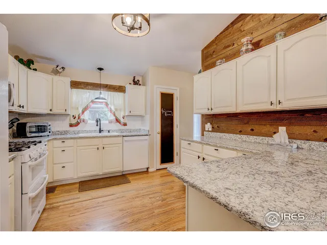 a kitchen with granite countertop a stove a sink and a granite counter tops