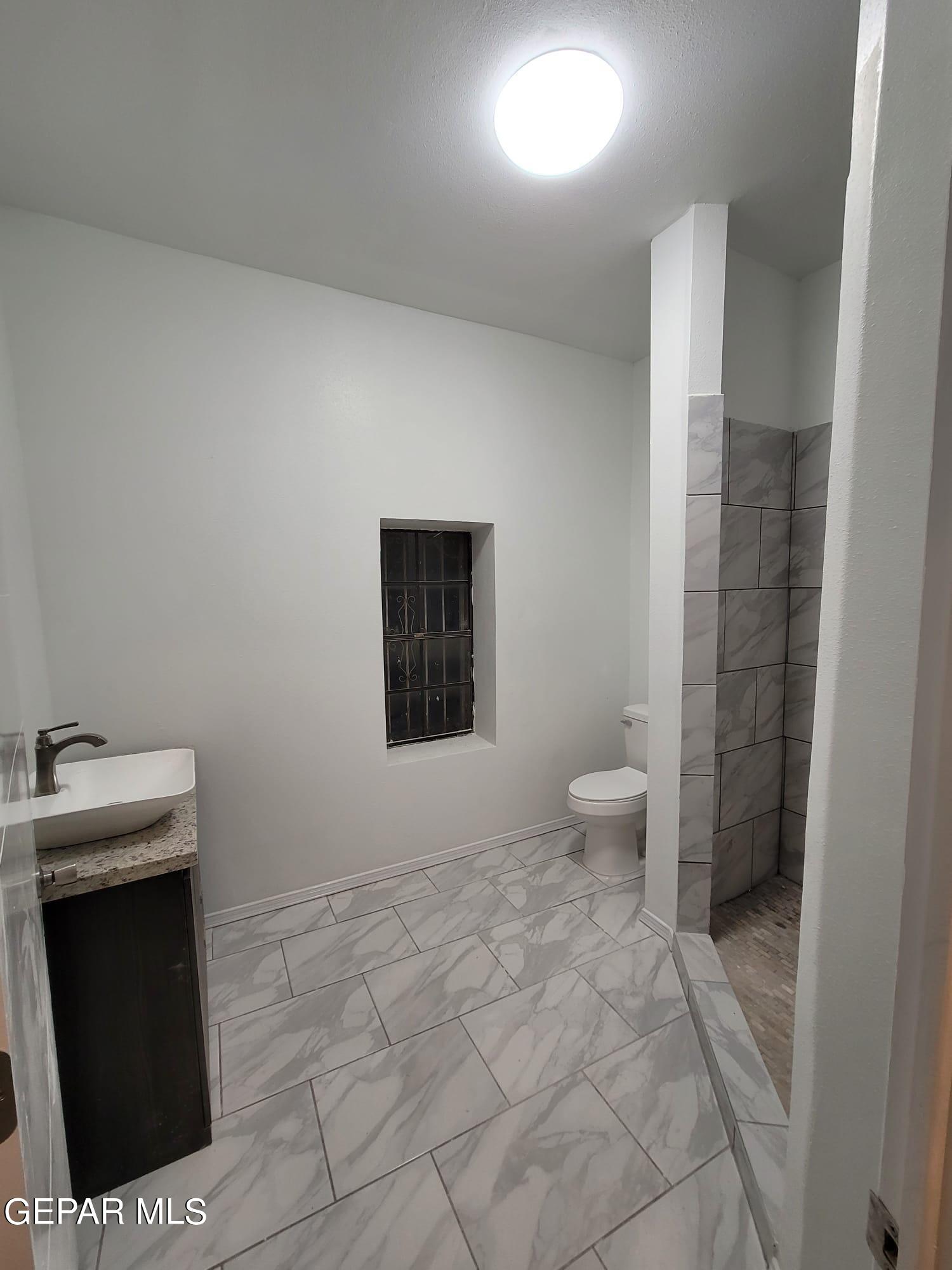 324 Valley Fair Way El Paso, TX 79907 - Photo 39 of 82 a bathroom with a sink and a toilet