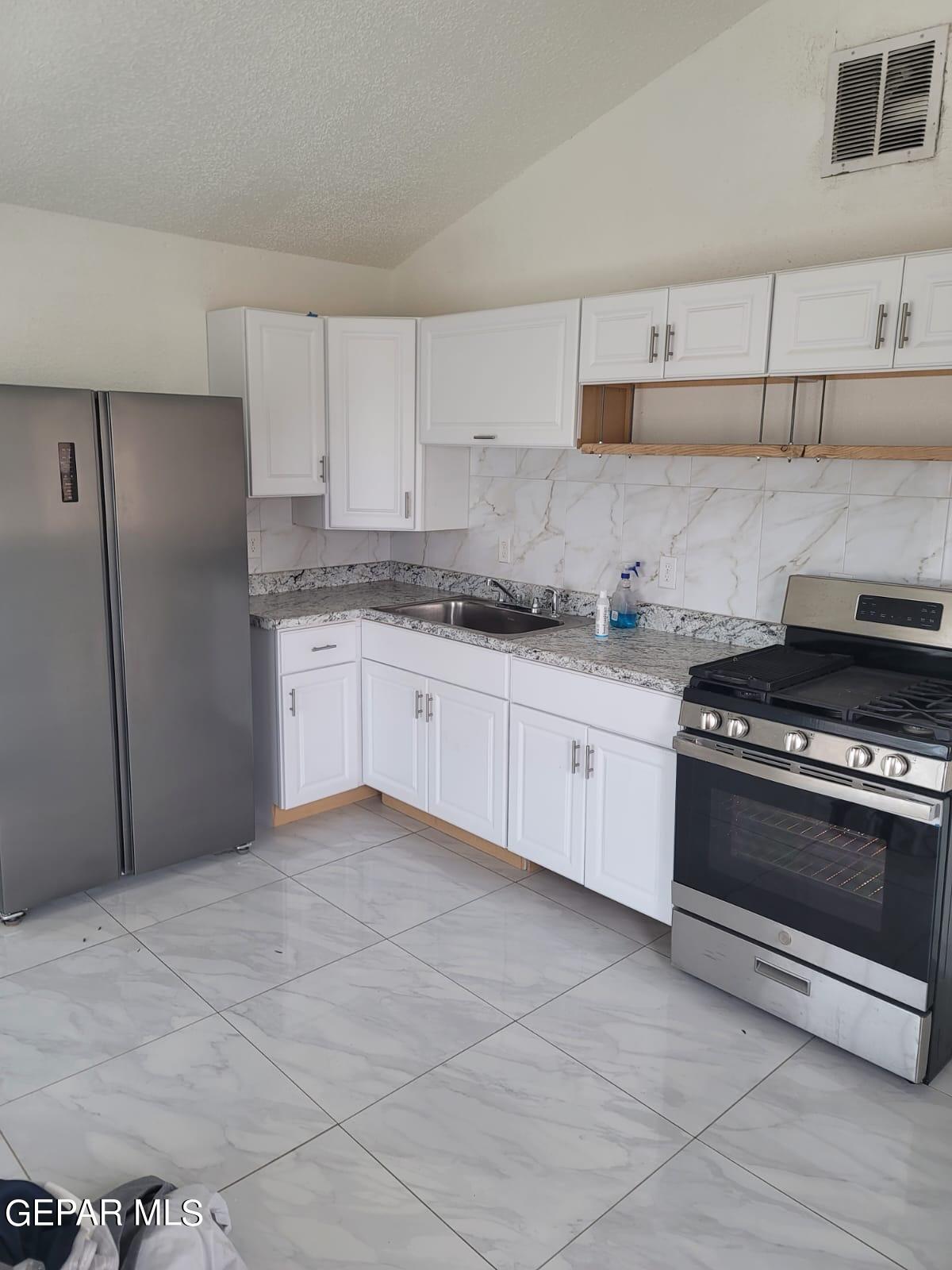 324 Valley Fair Way El Paso, TX 79907 - Photo 48 of 82 a kitchen with stainless steel appliances granite countertop a stove a sink and a refrigerator