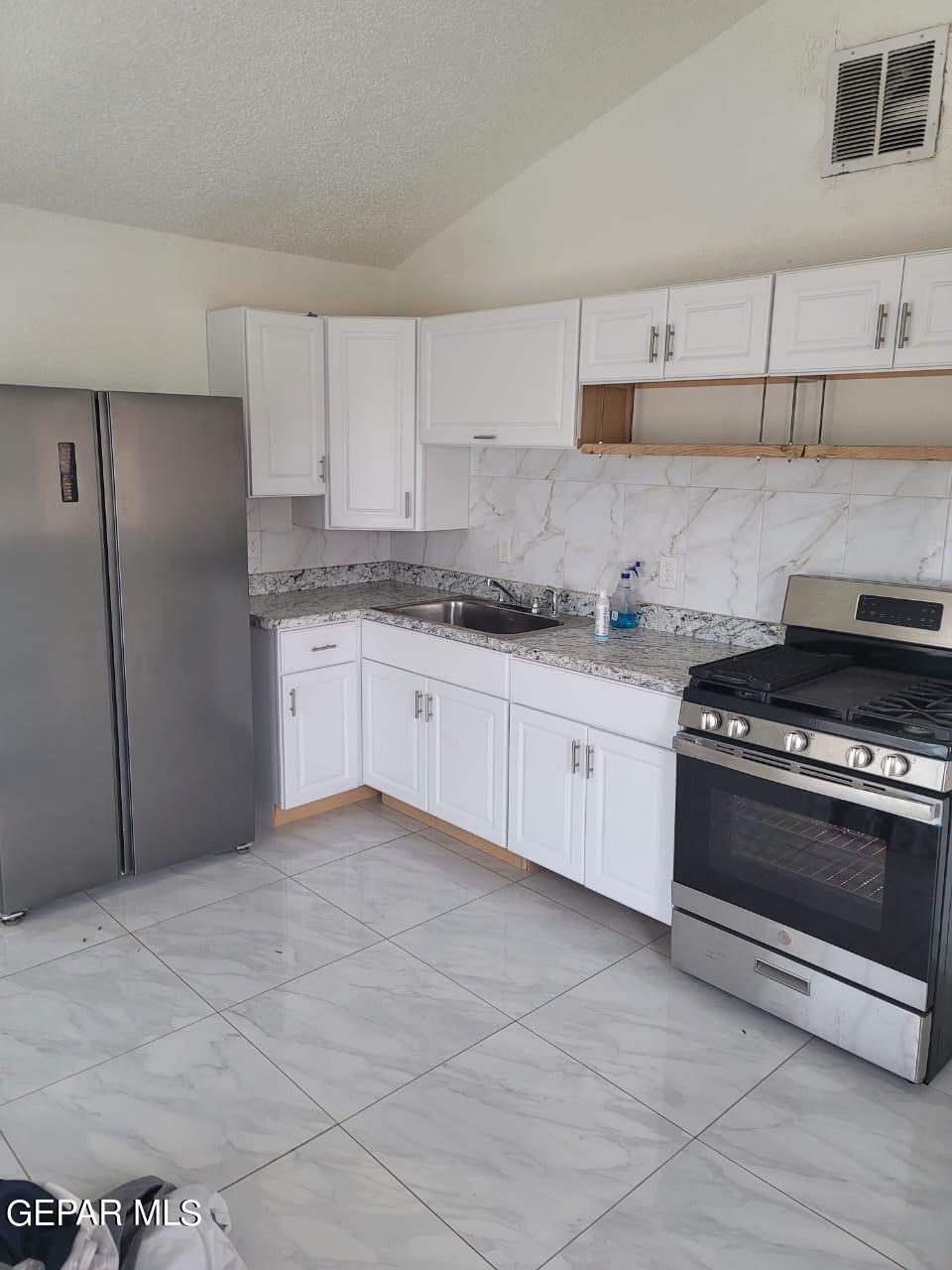 324 Valley Fair Way El Paso, TX 79907 - Photo 55 of 82 a kitchen with stainless steel appliances granite countertop a stove a sink and a refrigerator