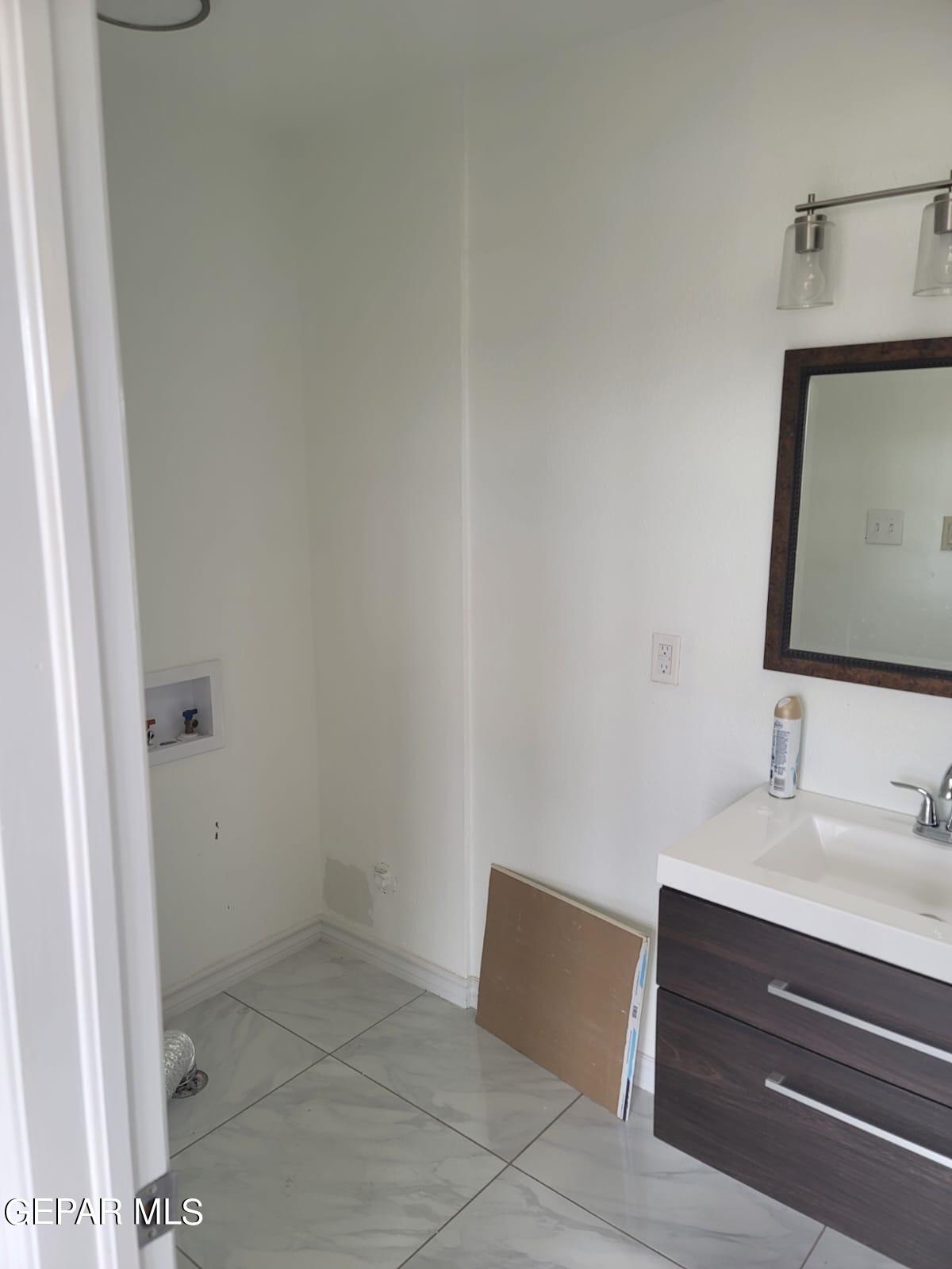 324 Valley Fair Way El Paso, TX 79907 - Photo 66 of 82 a bathroom with a sink and a mirror