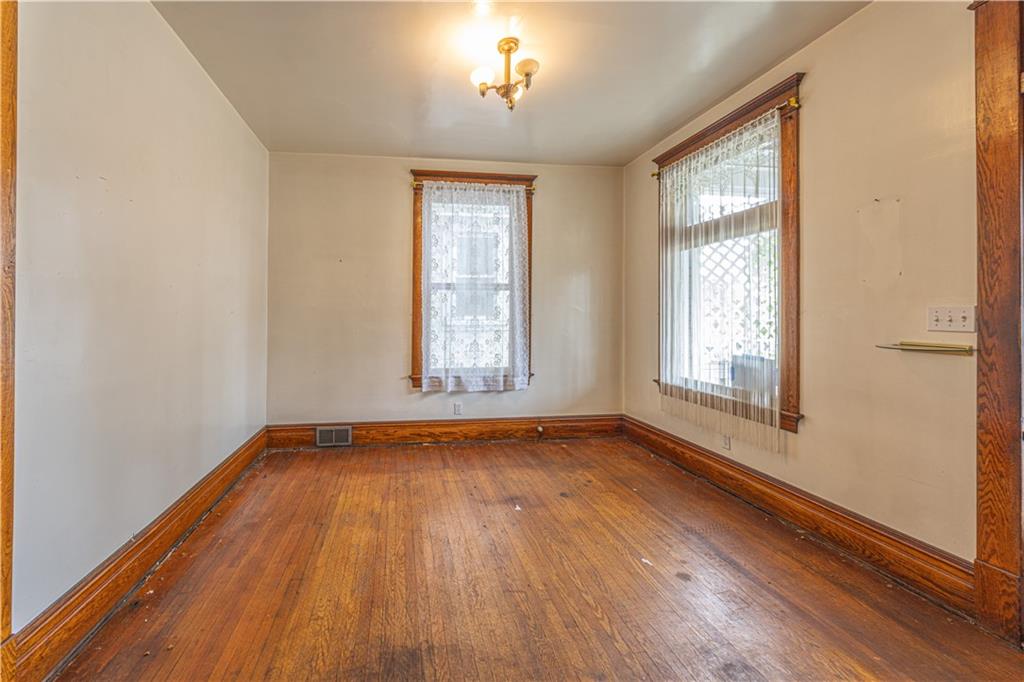 114 Union Street Uniontown, PA 15401 - Photo 3 of 28 an empty room with wooden floor and windows