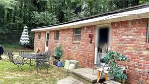 a front view of a house with outdoor seating