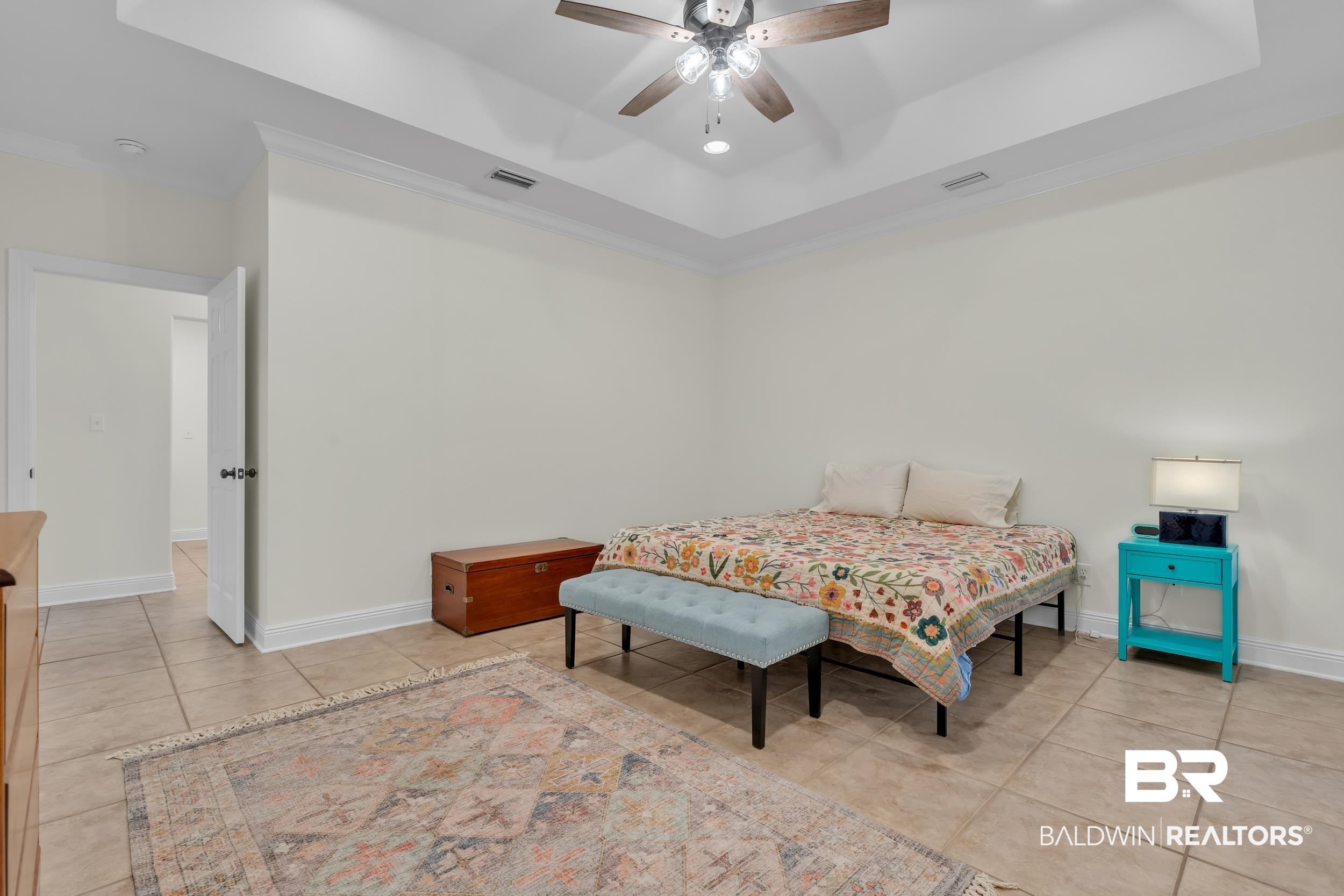4606 Osprey Drive Orange Beach, AL 36561 - Photo 27 of 44 Bedroom with tile patterned flooring, a raised ceiling, and ceiling fan