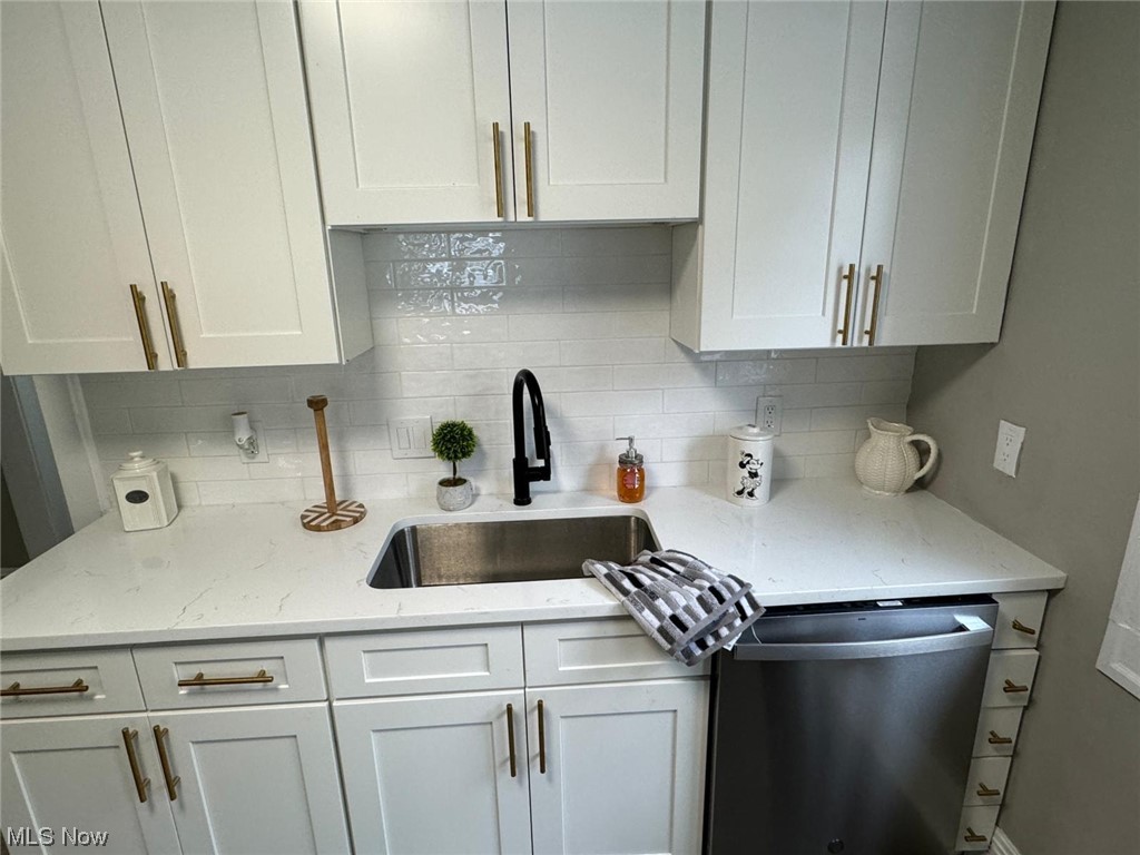 3333 Berea Road Cleveland, OH 44111 - Photo 7 of 34 Kitchen with tasteful backsplash, dishwasher, sink, and white cabinetry