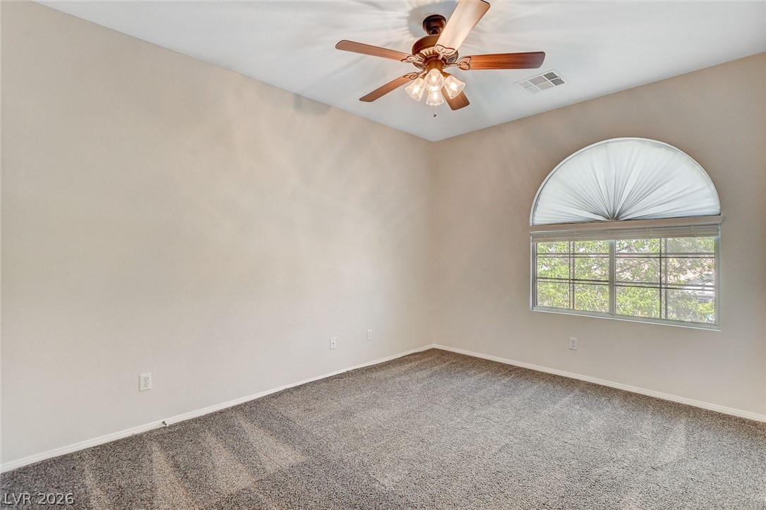 191 Verde Ridge Court Henderson, NV 89012 - Photo 28 of 36 Spare room with carpet floors, a ceiling fan, and baseboards