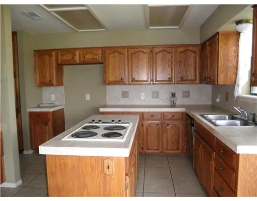 a kitchen that has a sink and a stove