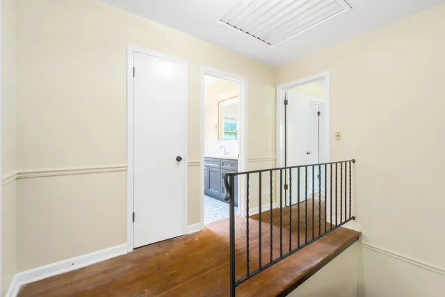 a view of a room with wooden floor