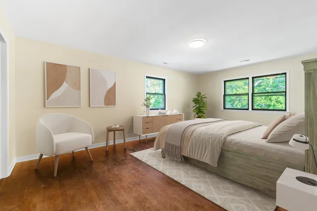 a bedroom with a bed and a chair