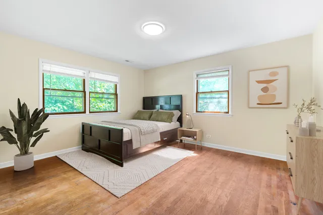 a bedroom with a large bed and a potted plant