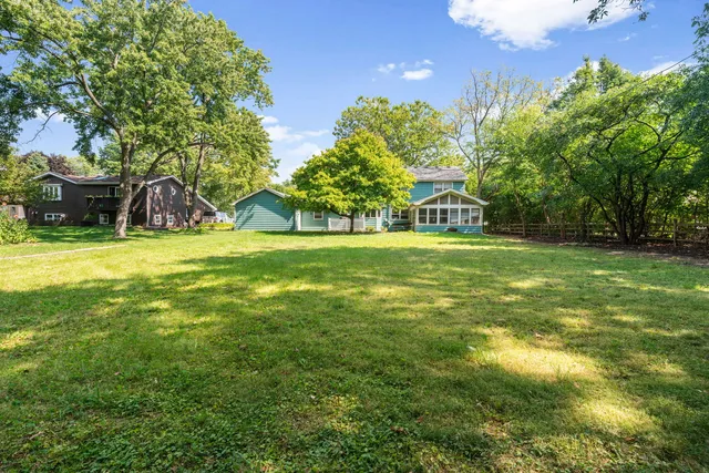 a view of a swimming pool and trees in the background