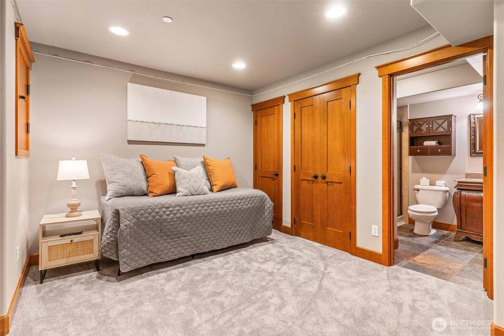 16454 108th Avenue Northeast Bothell, WA 98011 - Photo 32 of 40 a bedroom with a large bed and a chandelier