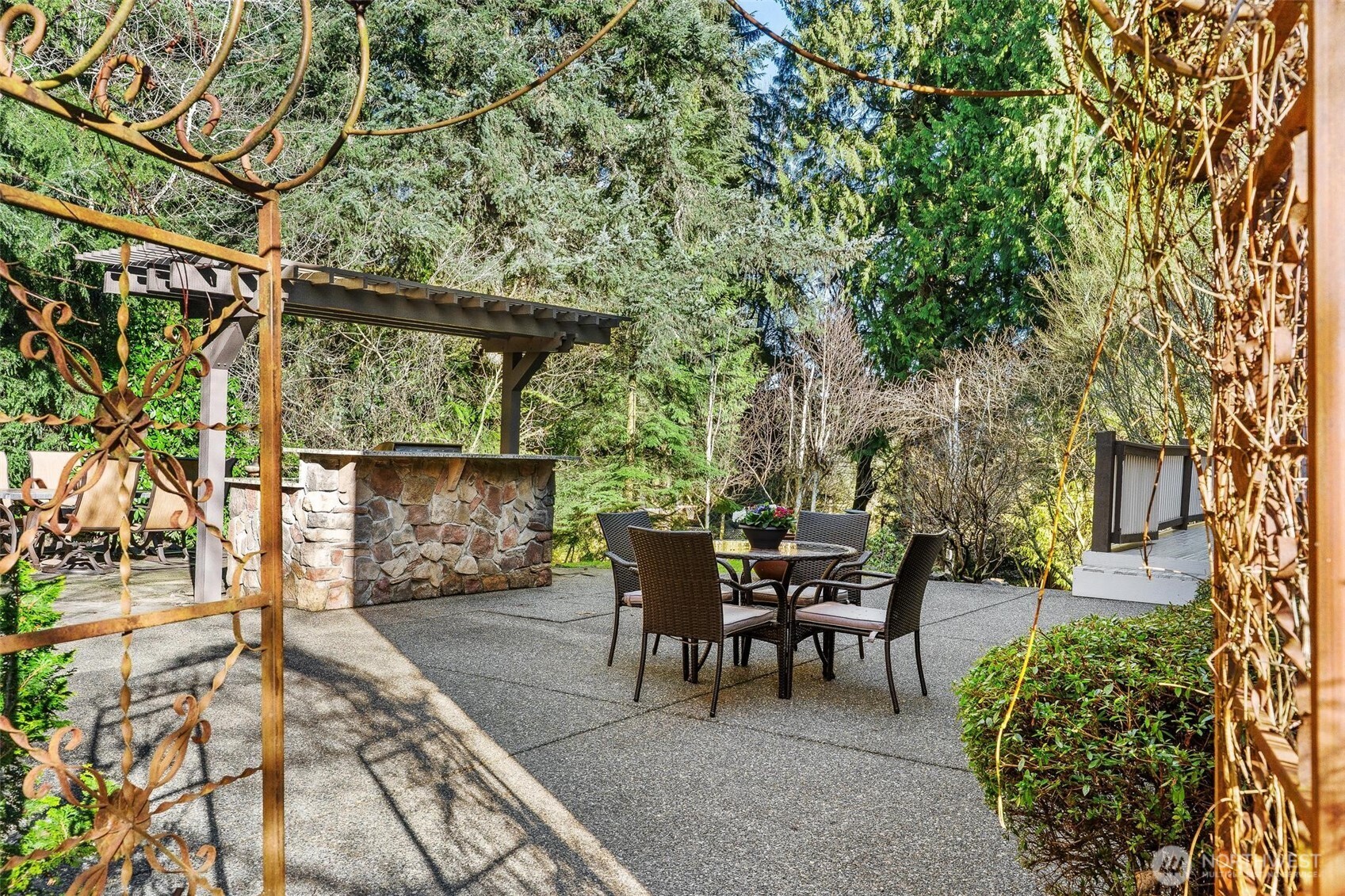 16454 108th Avenue Northeast Bothell, WA 98011 - Photo 36 of 40 a view of a patio with table and chairs and potted plants with wooden floor and fence