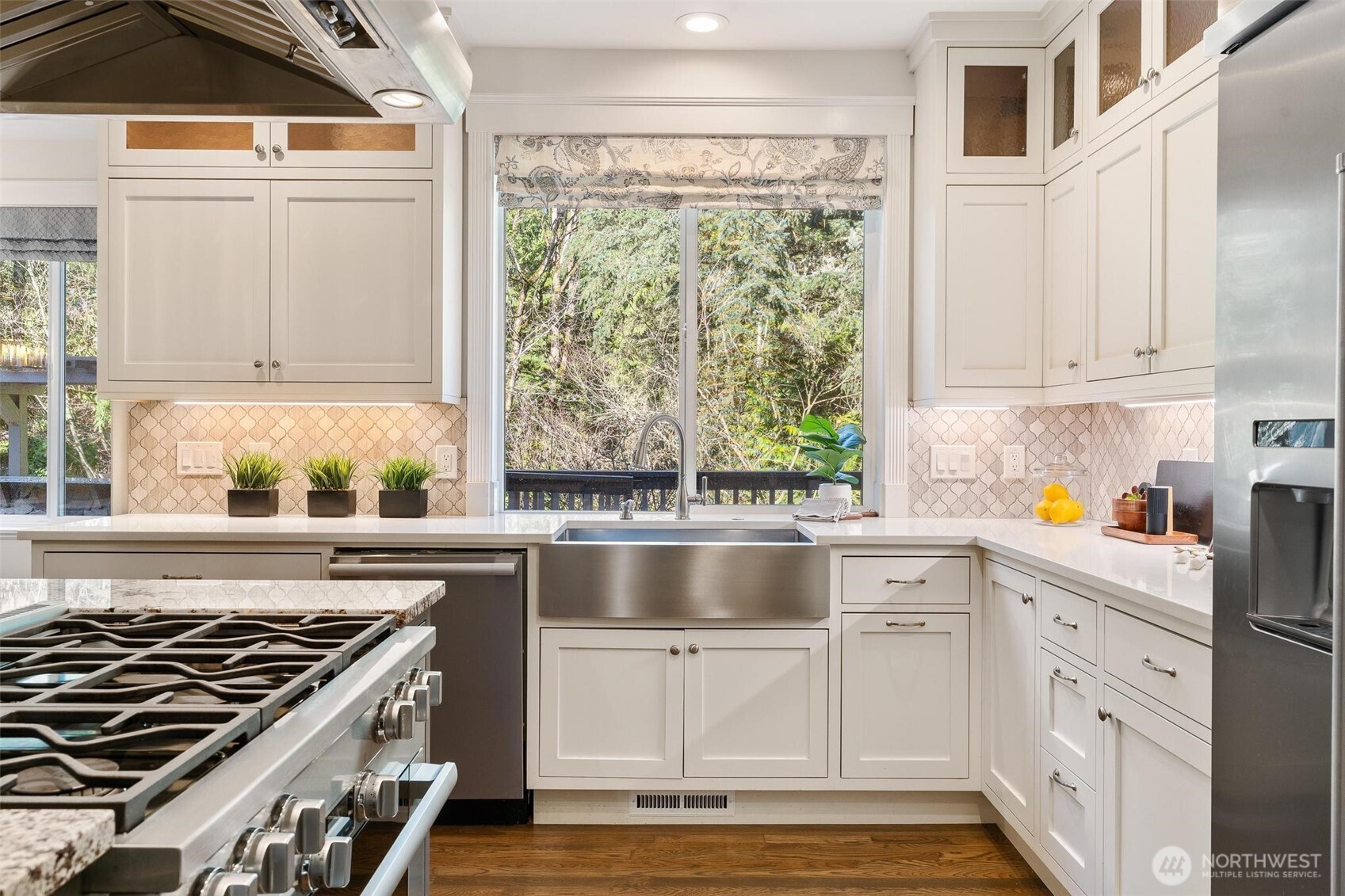 16454 108th Avenue Northeast Bothell, WA 98011 - Photo 8 of 40 a kitchen with granite countertop a stove and white cabinets