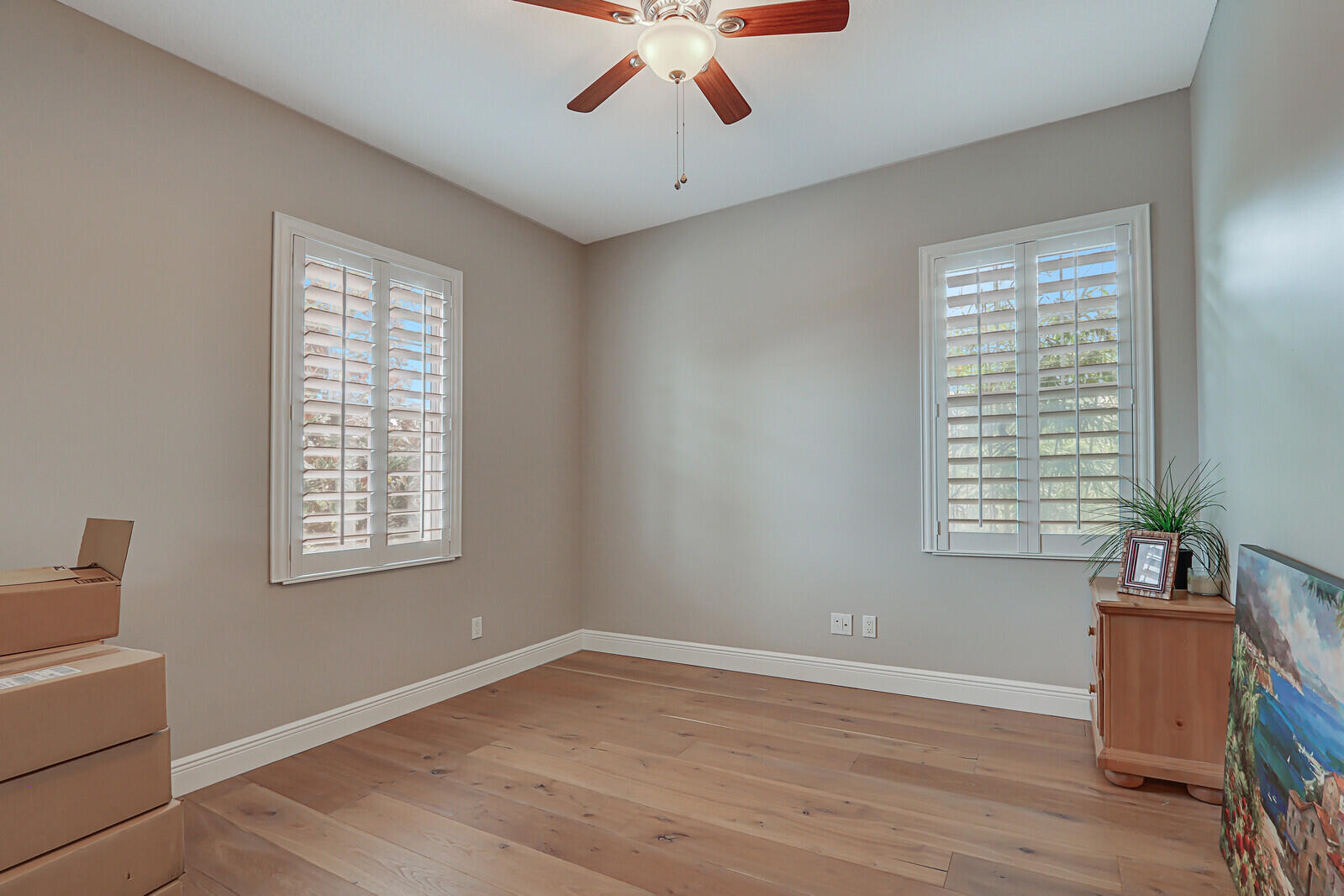 101 St Pierre Way Jupiter, FL 33458 - Photo 35 of 57 a view of an empty room with wooden floor and a window