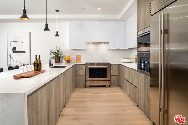 a kitchen with stainless steel appliances a sink and a refrigerator