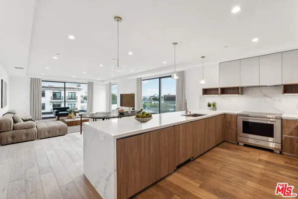 a large kitchen with stainless steel appliances lots of counter top space