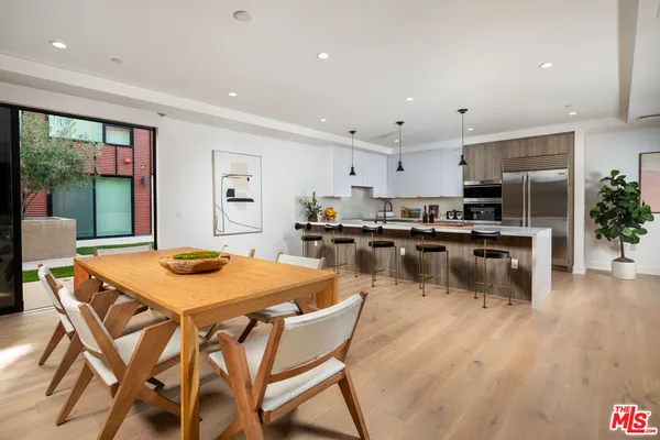 a kitchen with a table and chairs in it