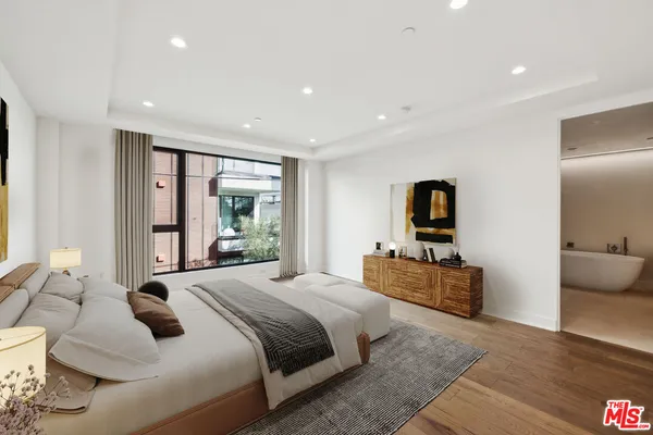 a bedroom with a large bed and a large window