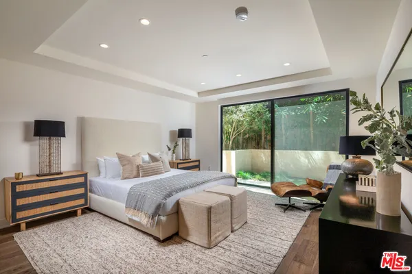 a bedroom with a bed and large window