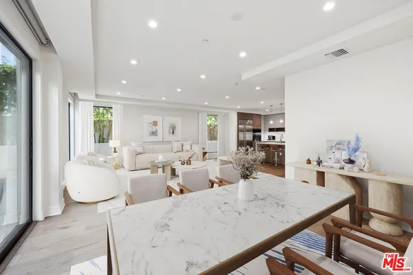 a living room with lots of furniture and white walls
