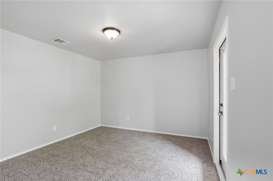 8716 Starview Street Temple, TX 76502 - Photo 14 of 36 Versatile bedroom or guest room with soft carpeting and neutral tones.
