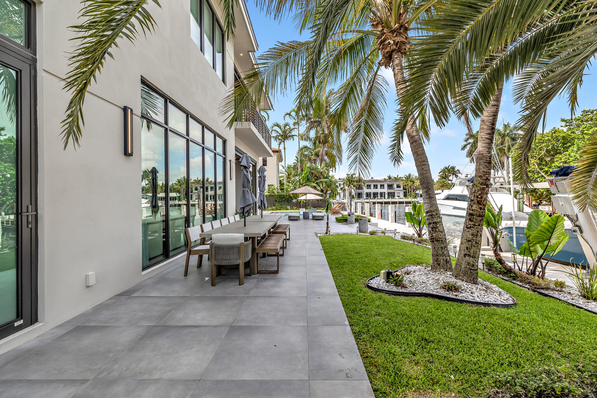 3711 Northeast 30th Avenue Lighthouse Point, FL 33064 - Photo 26 of 57 a view of a swimming pool with a table and chairs