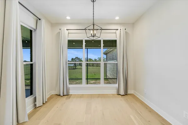 a view of an empty room with window and an outdoor view
