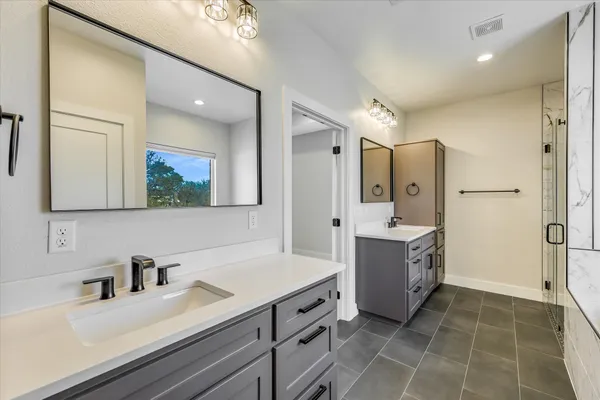 a spacious bathroom with a bathtub shower sink and mirror