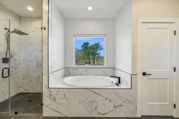a bathroom with a tub and a shower
