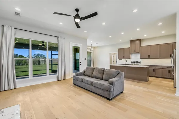a living room with furniture and a large window