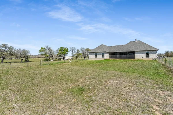 a view of a house with a yard and sitting area