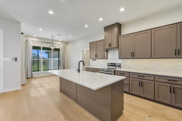 a kitchen with stainless steel appliances a sink stove and refrigerator